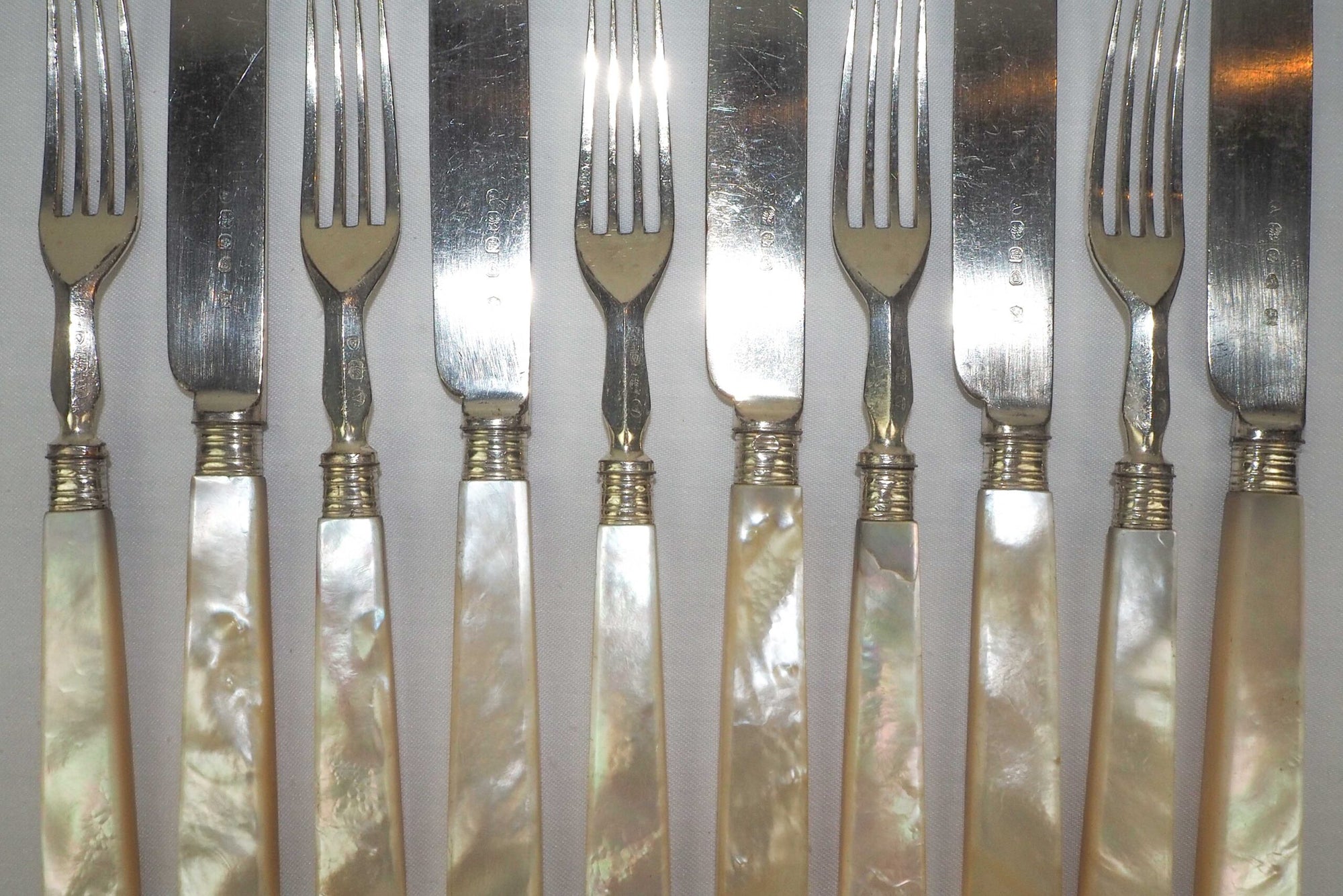 10 piece Antique Mother of Pearl Cutlery Set. The aged silver plate and mother of pearl handles give this set of knives and forks an antique look