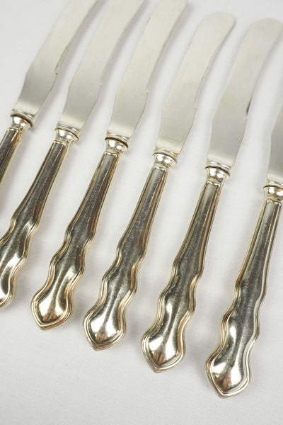 An Antique set of six Silver Plate Butter Knives with shapely tactile handles. 