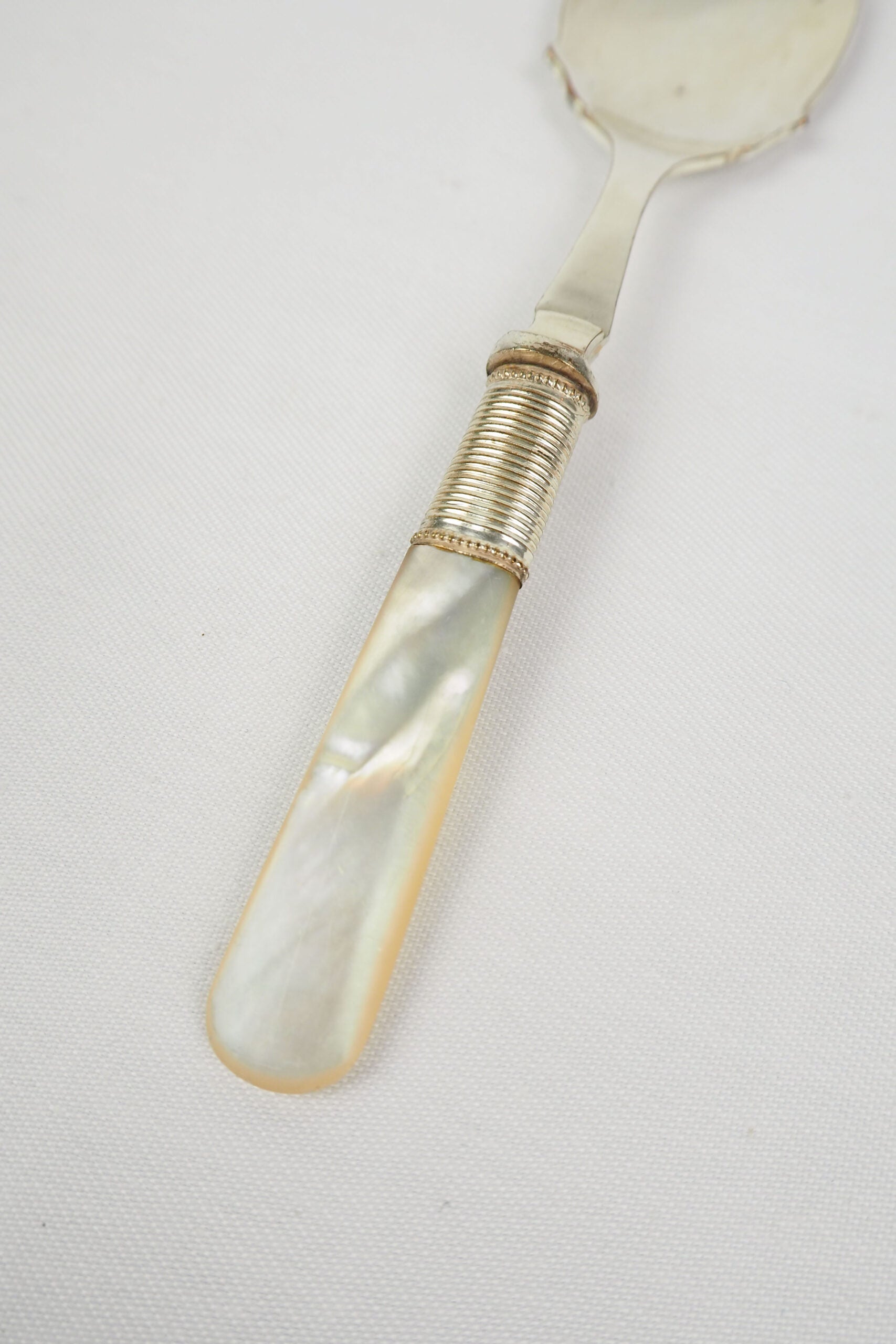 An Antique Jam Spoon With a Mother of Pearl handle and a Silver Plated neck and shallow bowl. An incredibly useful and beautiful piece of cutlery.