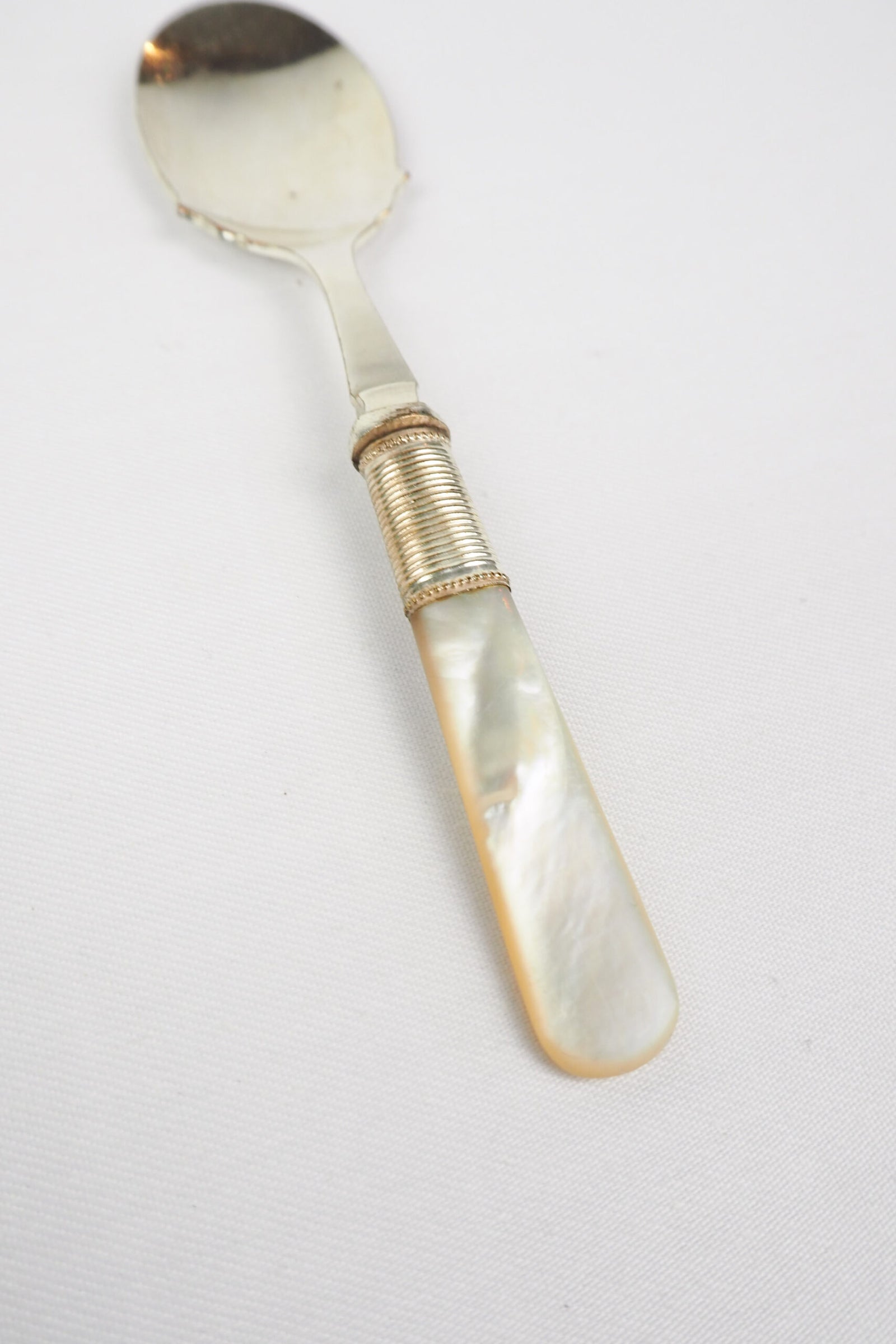 An Antique Jam Spoon With a Mother of Pearl handle and a Silver Plated neck and shallow bowl. An incredibly useful and beautiful piece of cutlery.