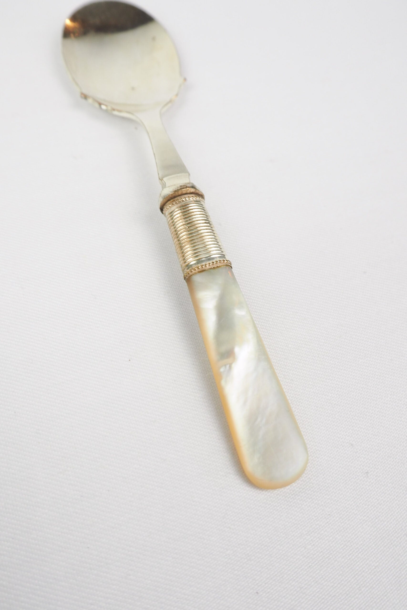 An Antique Jam Spoon With a Mother of Pearl handle and a Silver Plated neck and shallow bowl. An incredibly useful and beautiful piece of cutlery.
