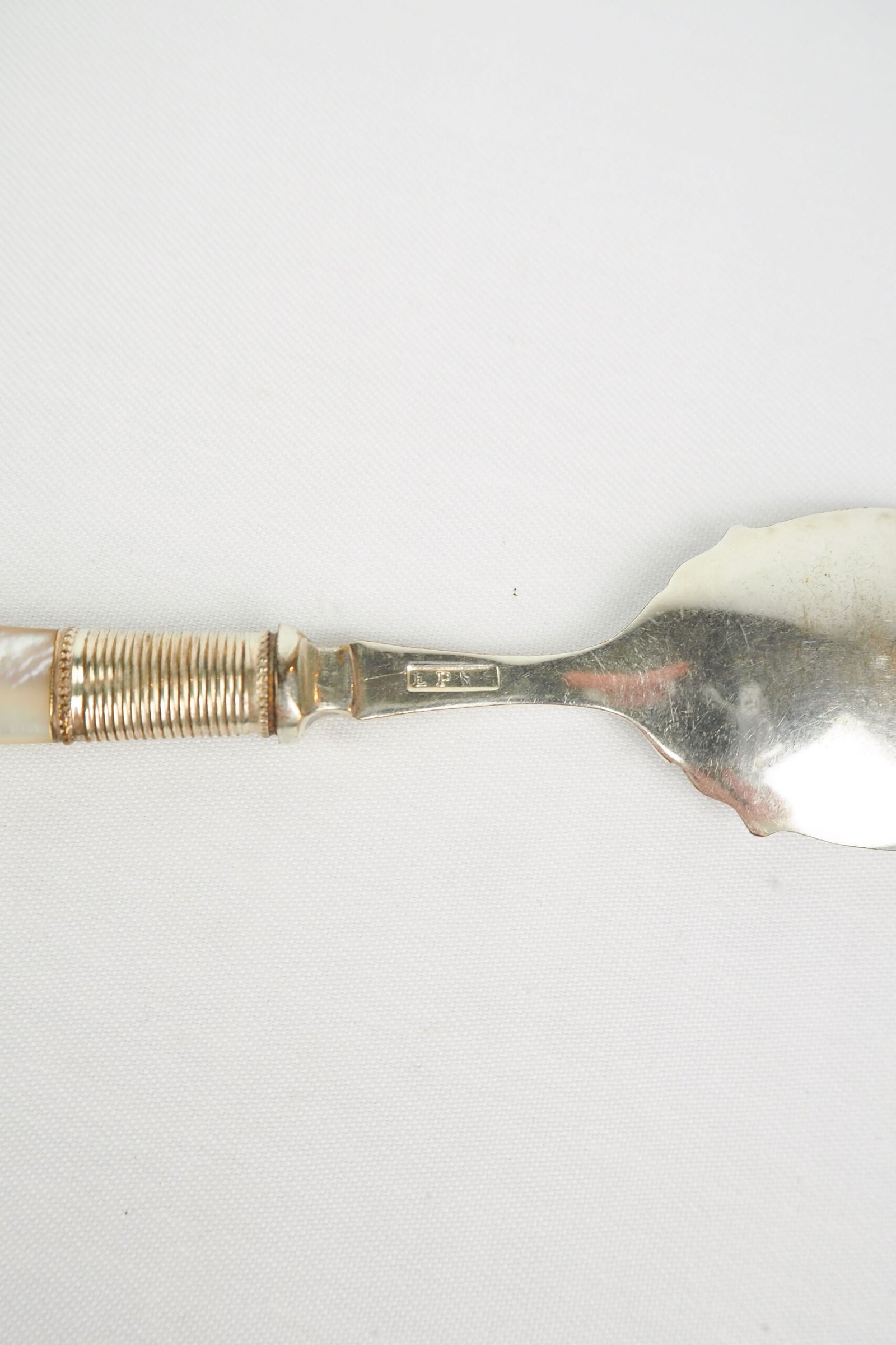 An Antique Jam Spoon With a Mother of Pearl handle and a Silver Plated neck and shallow bowl. An incredibly useful and beautiful piece of cutlery.