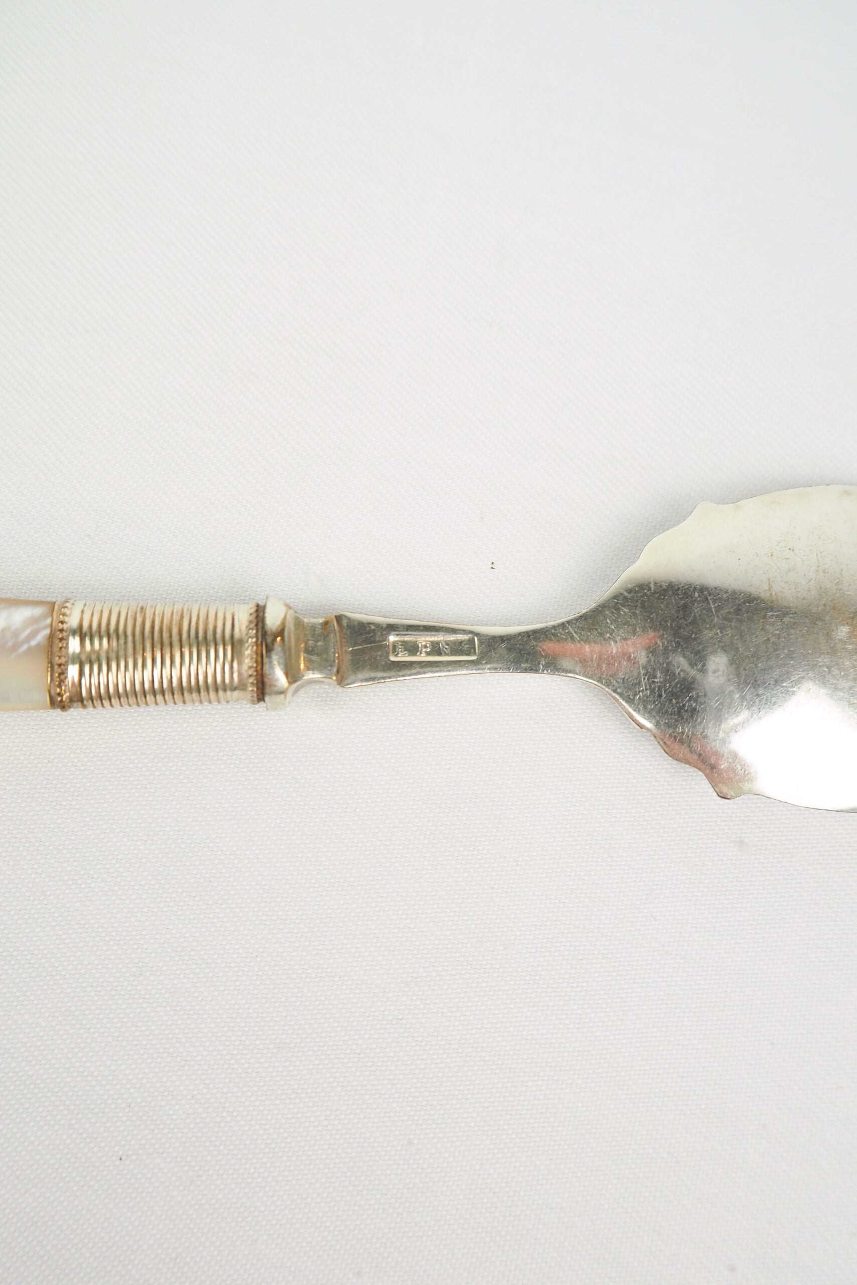 An Antique Jam Spoon With a Mother of Pearl handle and a Silver Plated neck and shallow bowl. An incredibly useful and beautiful piece of cutlery.