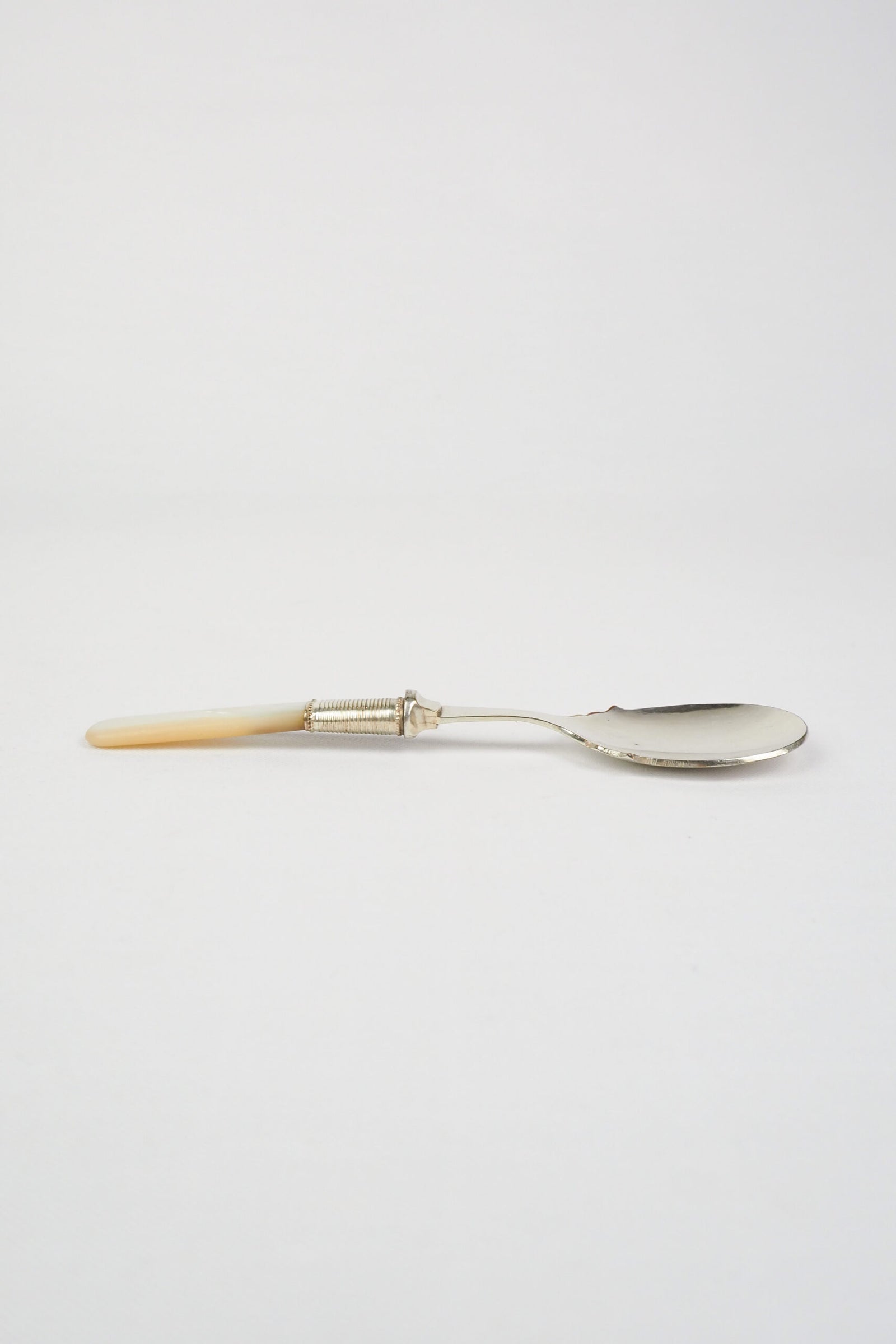 An Antique Jam Spoon With a Mother of Pearl handle and a Silver Plated neck and shallow bowl. An incredibly useful and beautiful piece of cutlery.