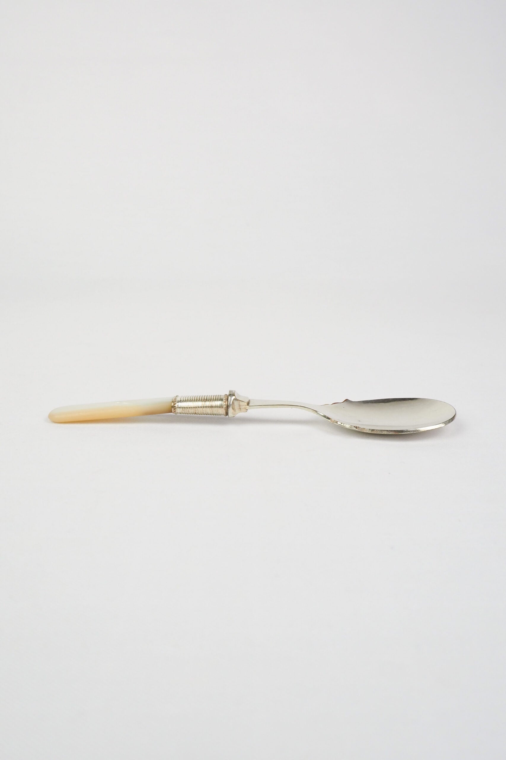 An Antique Jam Spoon With a Mother of Pearl handle and a Silver Plated neck and shallow bowl. An incredibly useful and beautiful piece of cutlery.