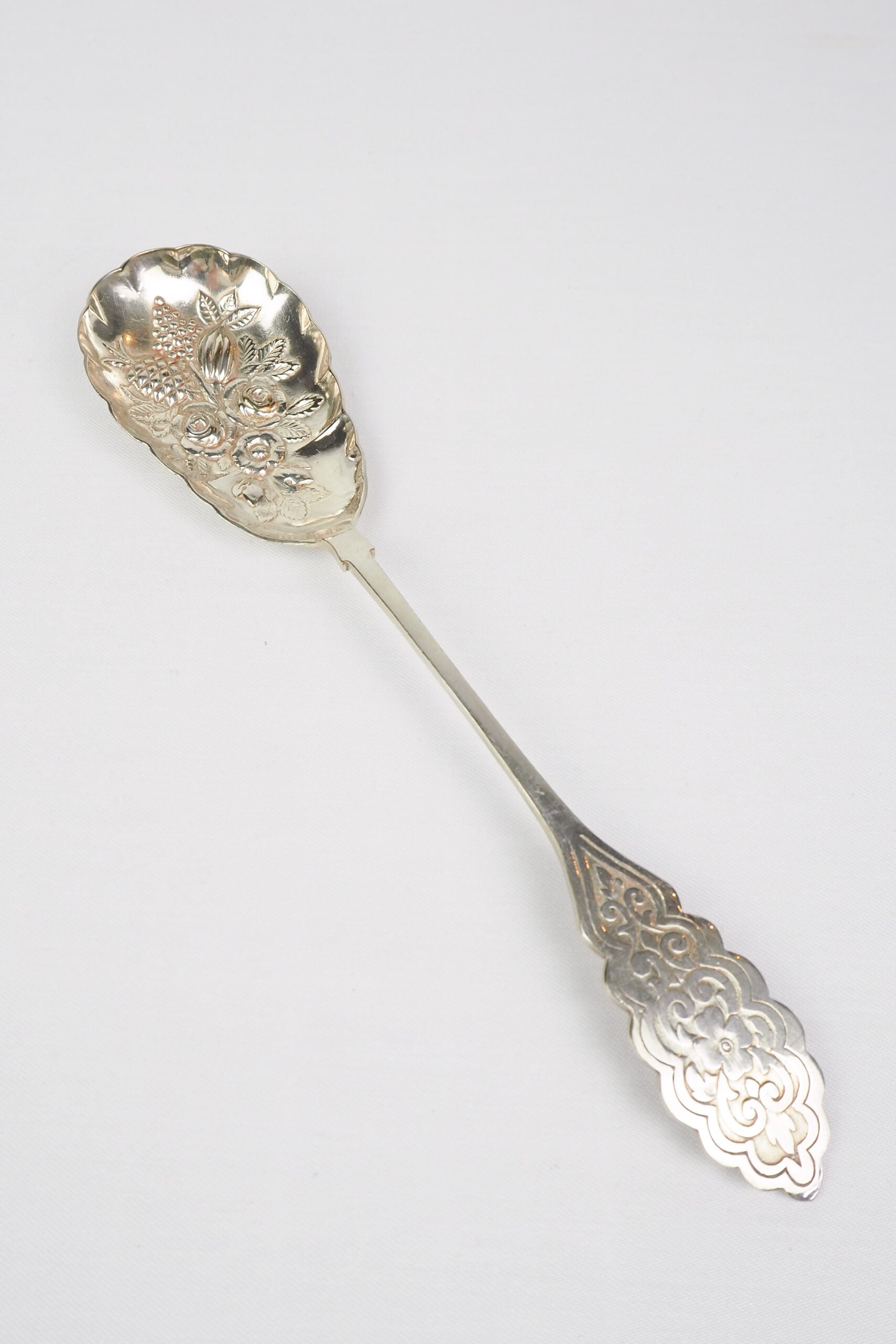 An Antique Fruit Salad Spoon With a stunning pressed pattern through the Silver Plated neck and bowl.