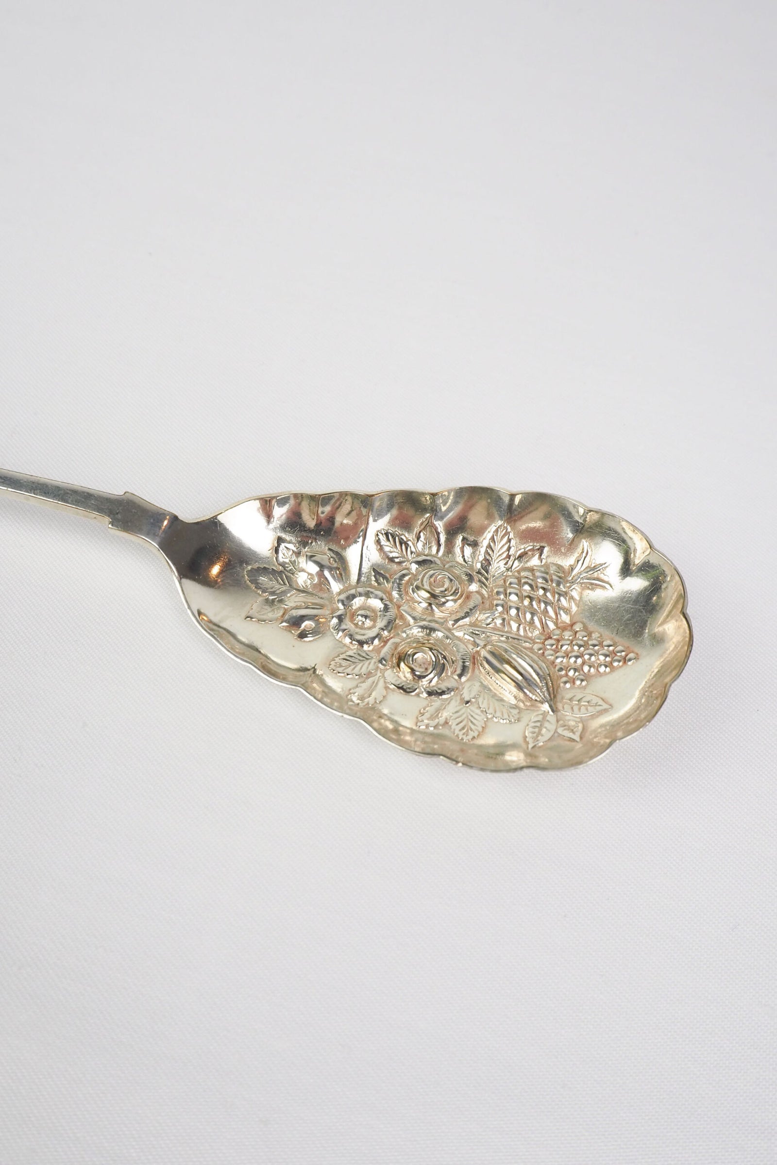 An Antique Fruit Salad Spoon With a stunning pressed pattern through the Silver Plated neck and bowl.