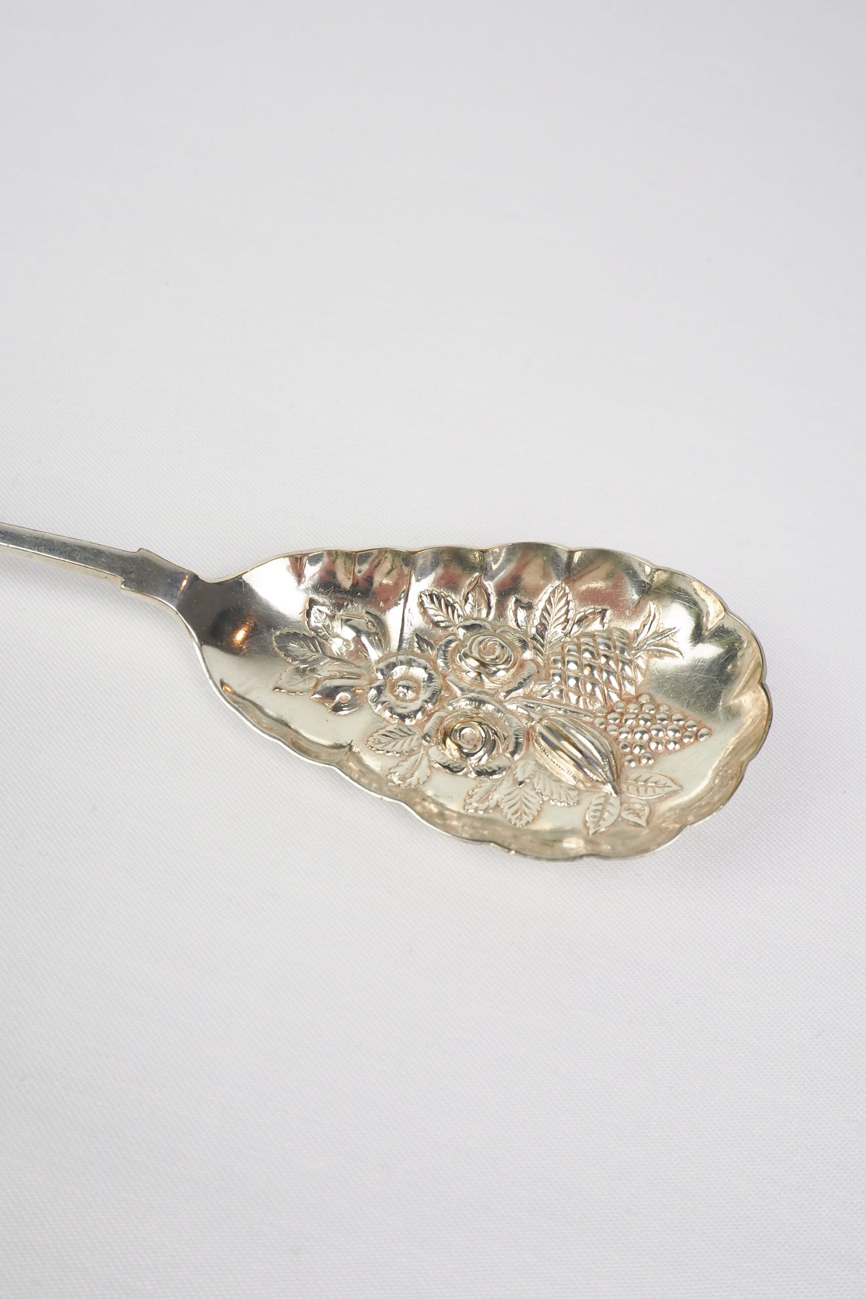 An Antique Fruit Salad Spoon With a stunning pressed pattern through the Silver Plated neck and bowl.