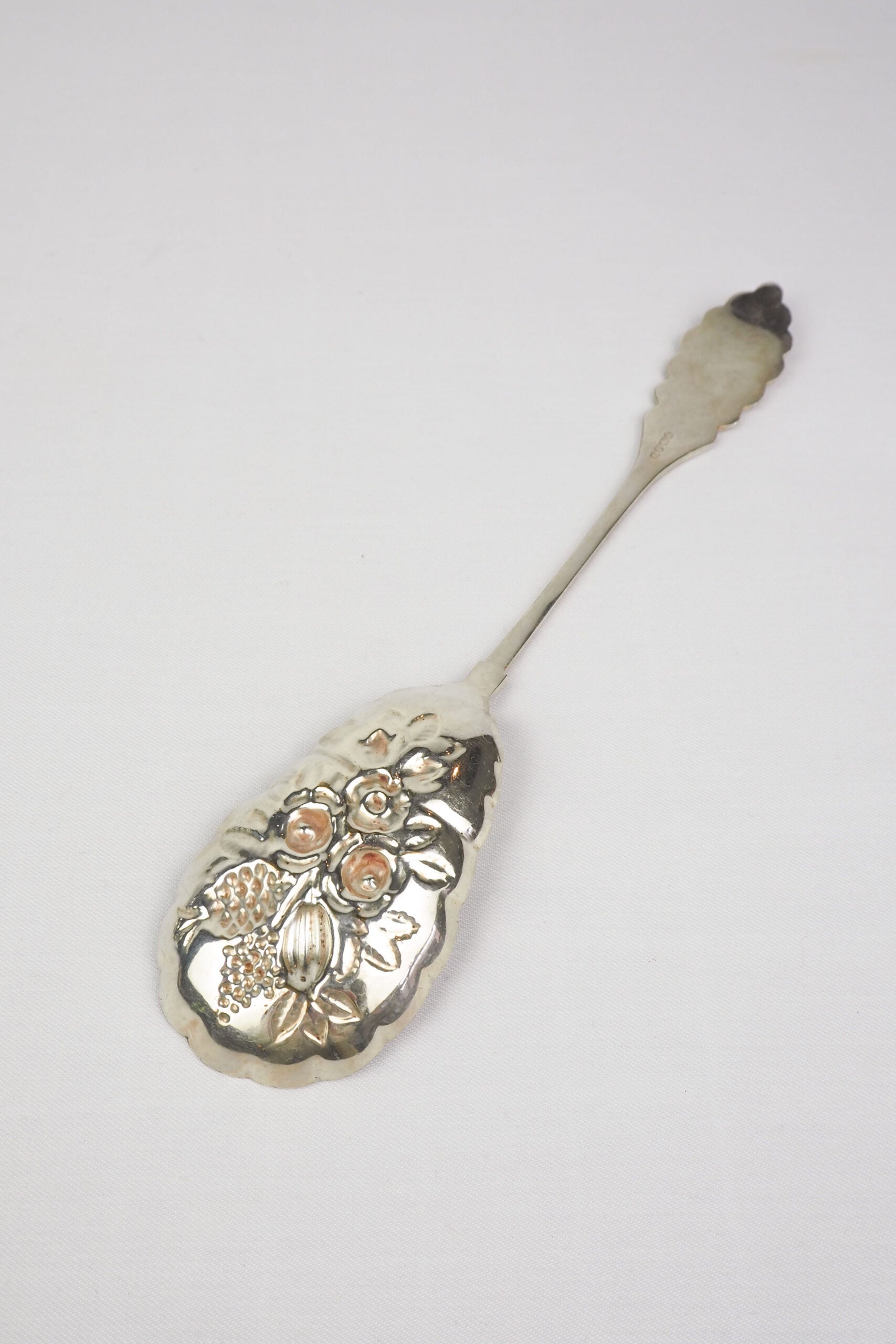 An Antique Fruit Salad Spoon With a stunning pressed pattern through the Silver Plated neck and bowl.