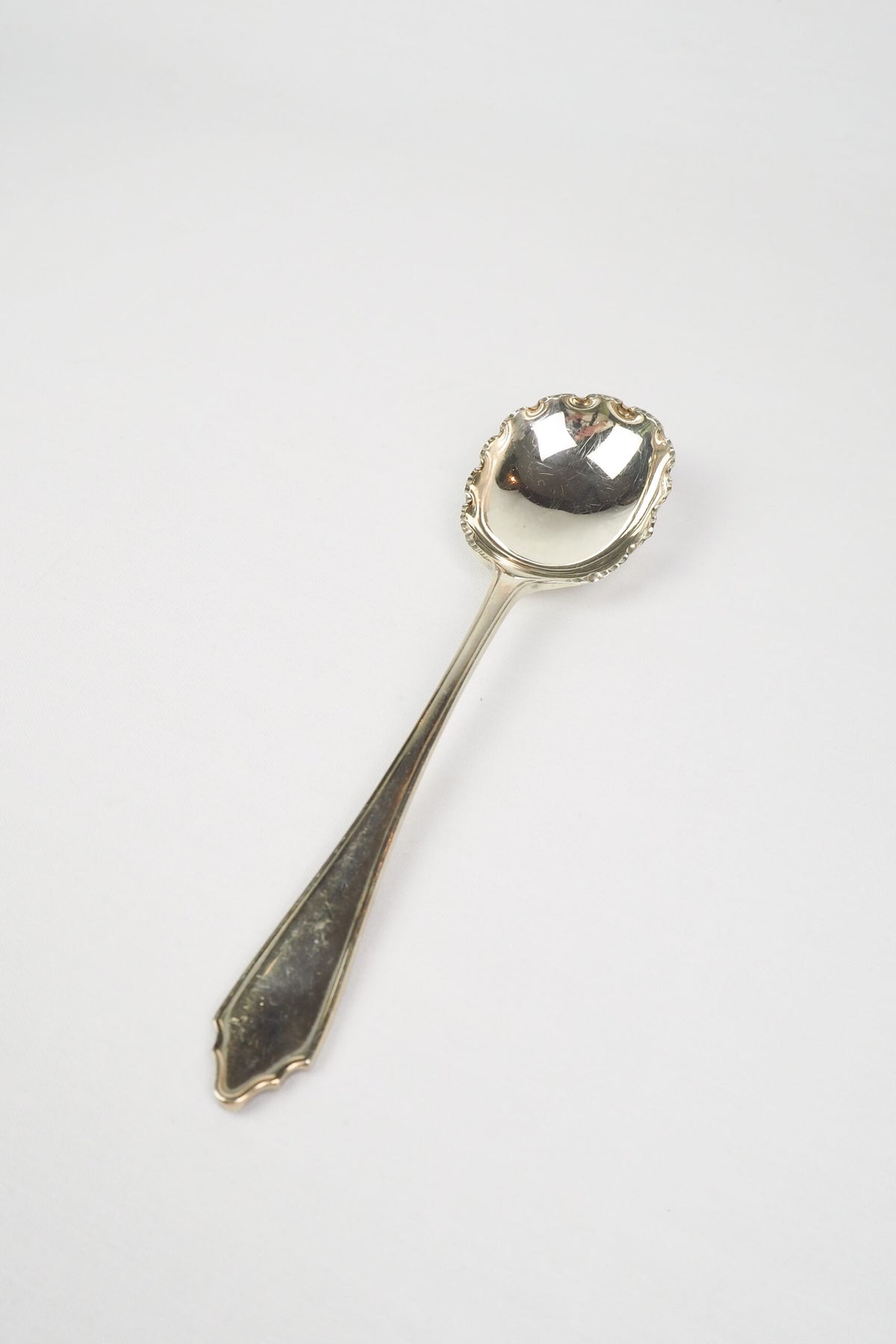 This stunning Antique Fruit Salad Spoon is the perfect piece for your kitchen. With an incredible crimped edge bowl of the spoon and a decorative handle