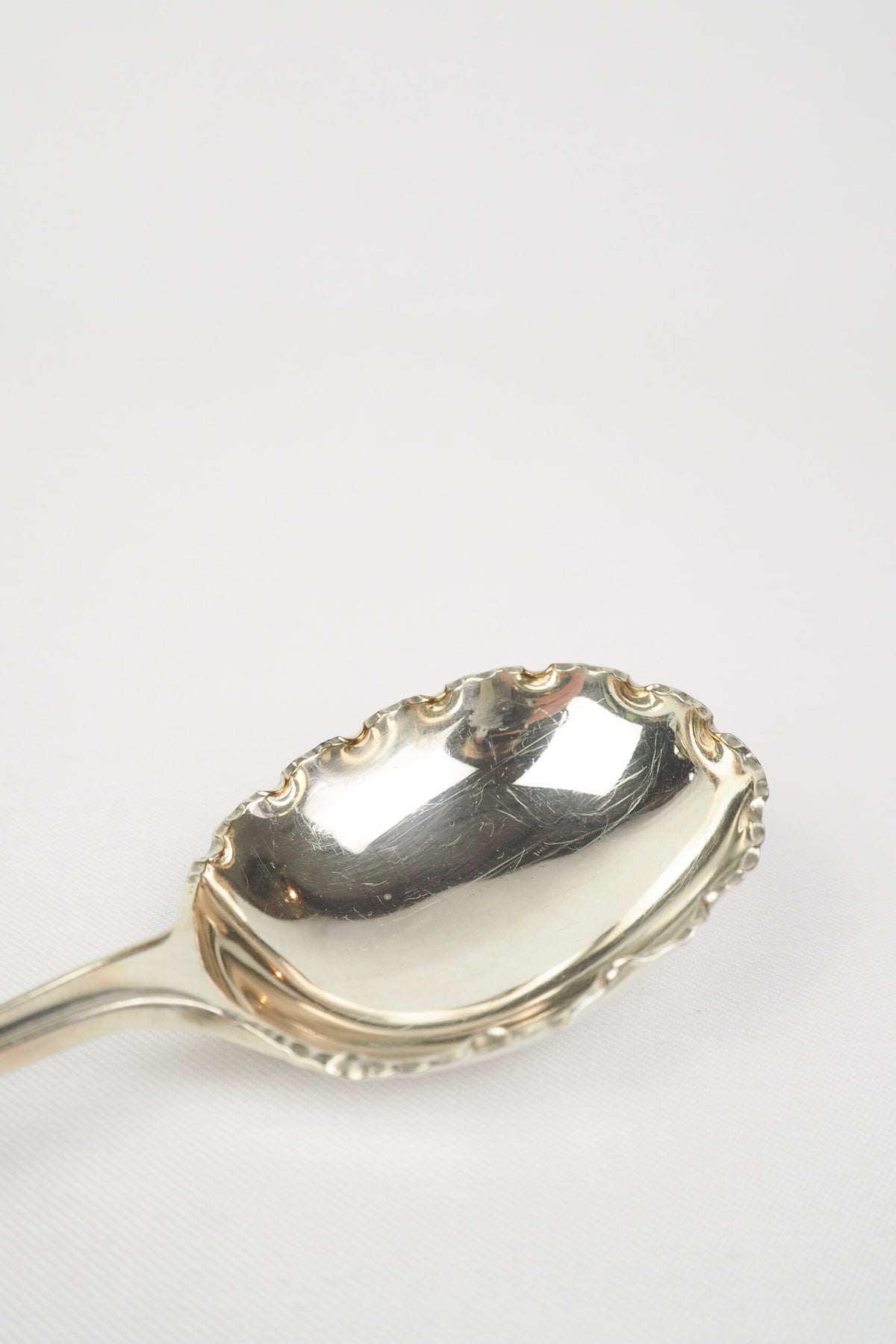This stunning Antique Fruit Salad Spoon is the perfect piece for your kitchen. With an incredible crimped edge bowl of the spoon and a decorative handle