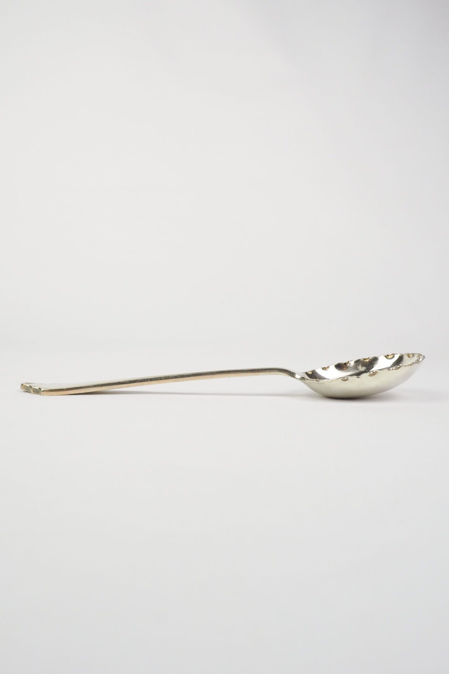 This stunning Antique Fruit Salad Spoon is the perfect piece for your kitchen. With an incredible crimped edge bowl of the spoon and a decorative handle
