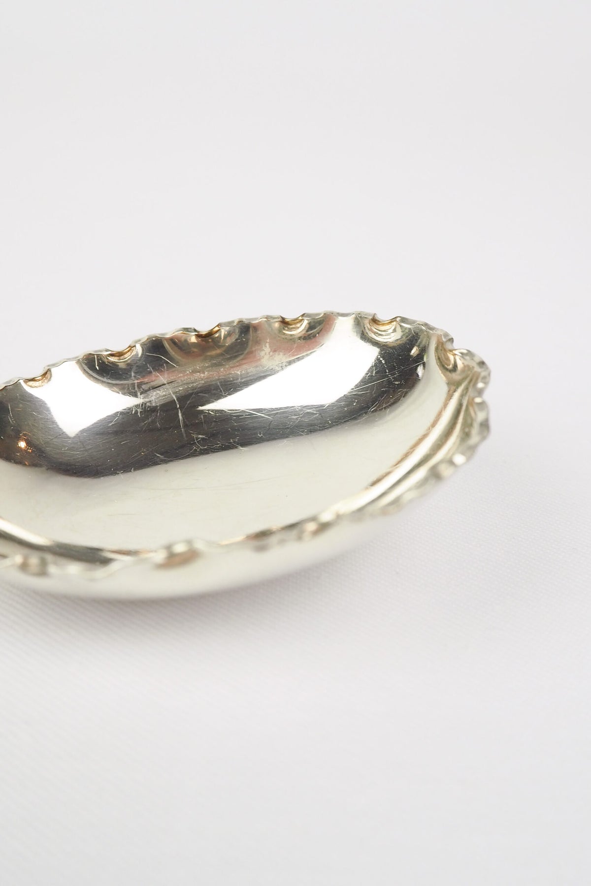 This stunning Antique Fruit Salad Spoon is the perfect piece for your kitchen. With an incredible crimped edge bowl of the spoon and a decorative handle