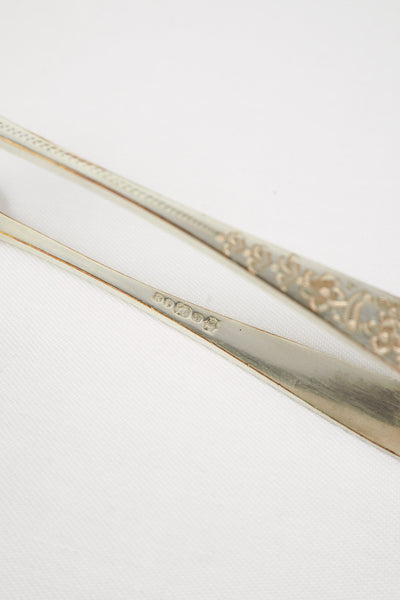 This Vintage Set of Silver Plate Sugar Tongs have a vintage stone washed patina to the silver plate and a decorative etched floral pattern. 