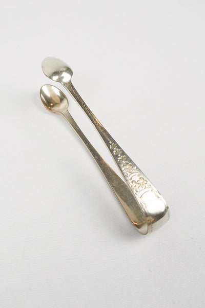 This Vintage Set of Silver Plate Sugar Tongs have a vintage stone washed patina to the silver plate and a decorative etched floral pattern. 