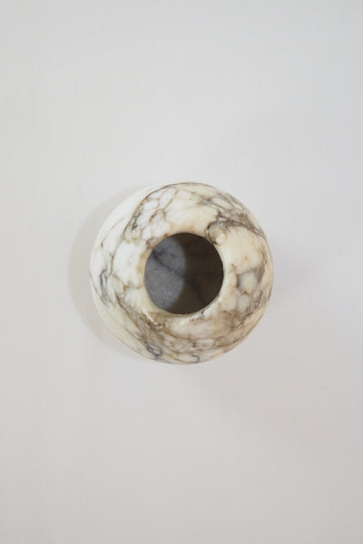 A Vintage Spherical Marble Vase with dark veins running through the white marble. Wildmore