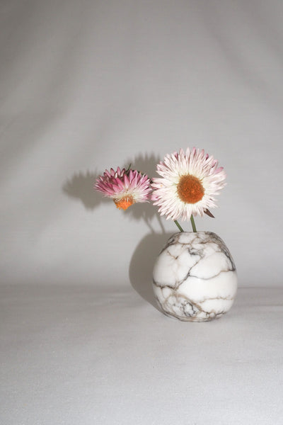A Vintage Spherical Marble Vase with dark veins running through the white marble. Wildmore
