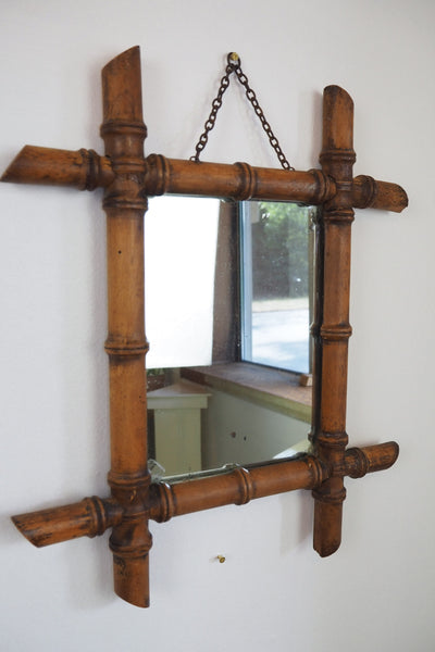 A stunning example of an early Antique French Faux Bamboo Mirror. This beautifully foxed glass is framed by a hand turned wooden frame.