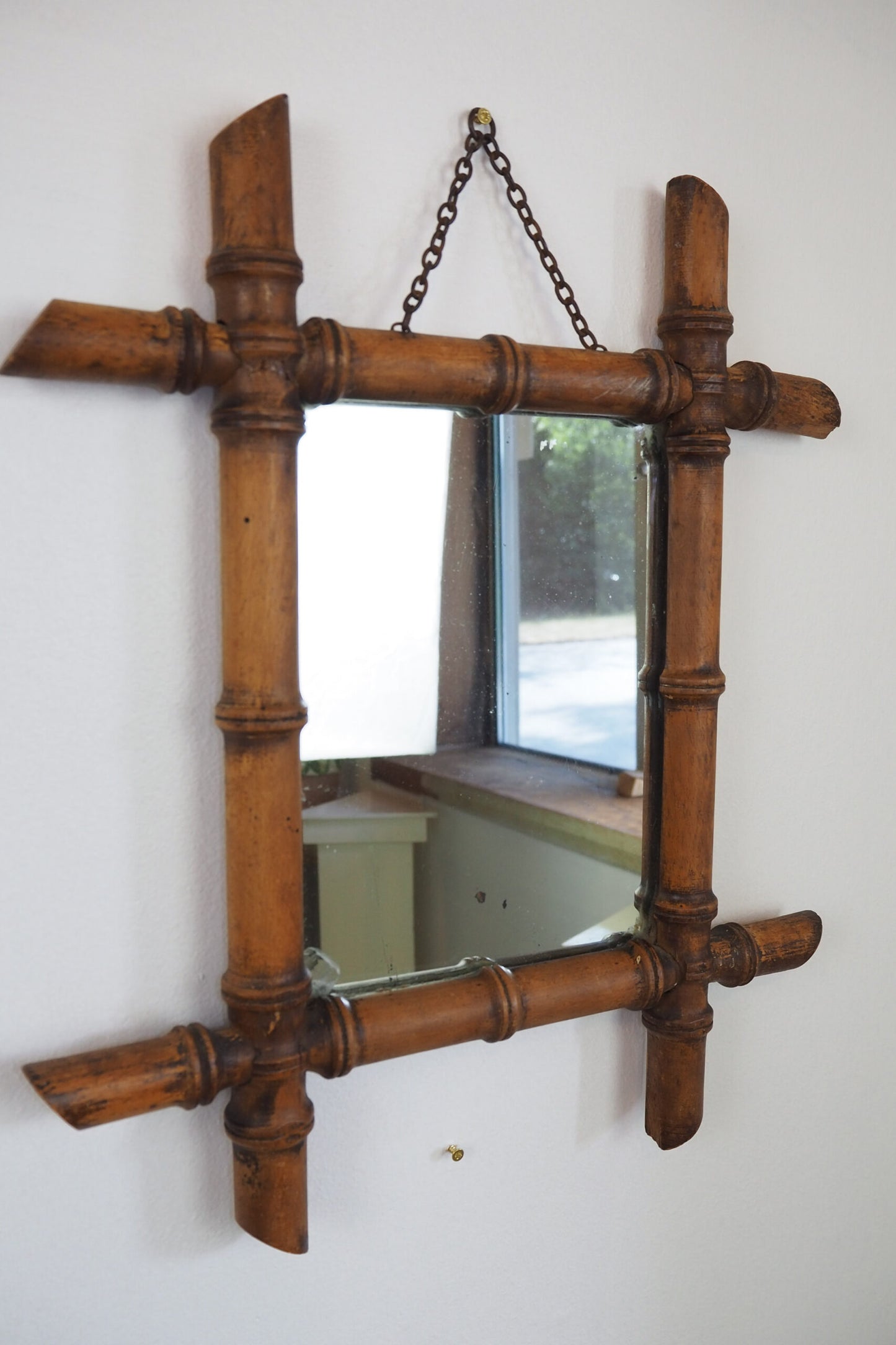 A stunning example of an early Antique French Faux Bamboo Mirror. This beautifully foxed glass is framed by a hand turned wooden frame.