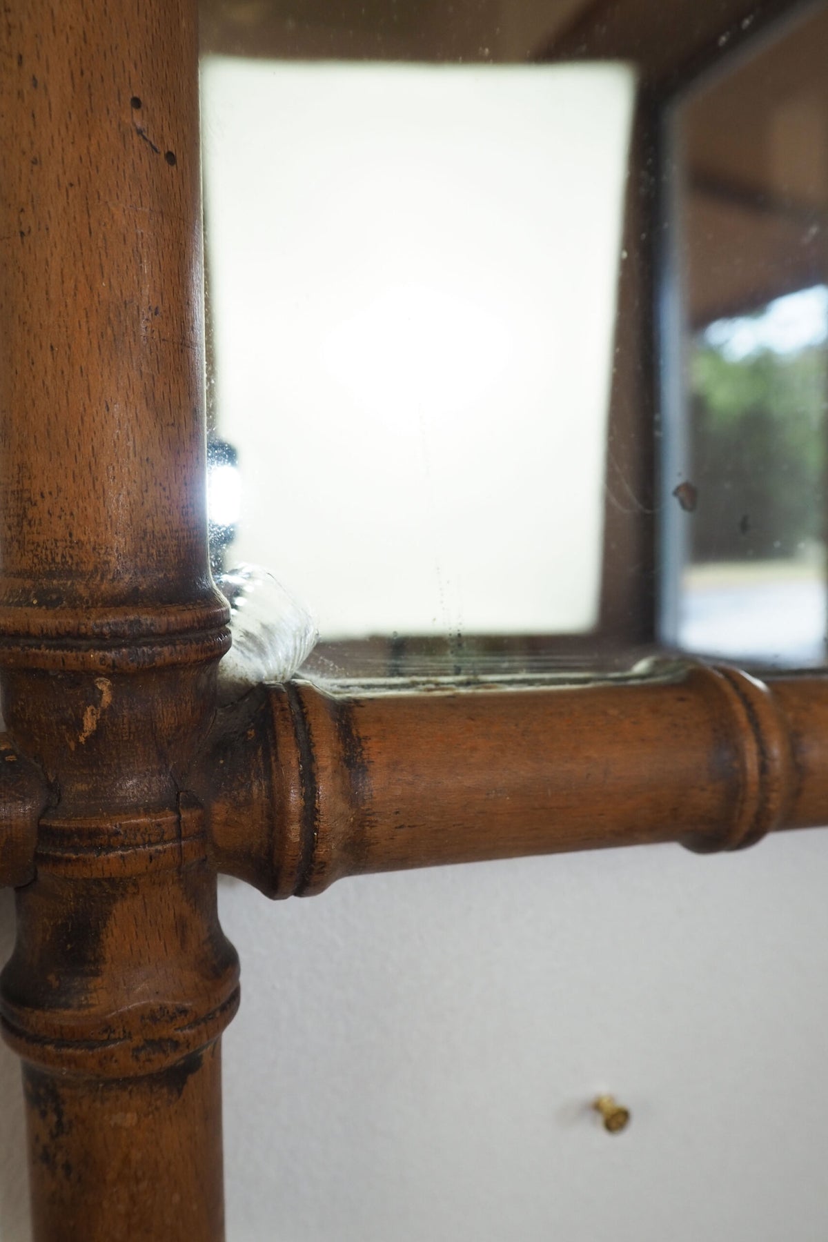 A stunning example of an early Antique French Faux Bamboo Mirror. This beautifully foxed glass is framed by a hand turned wooden frame.
