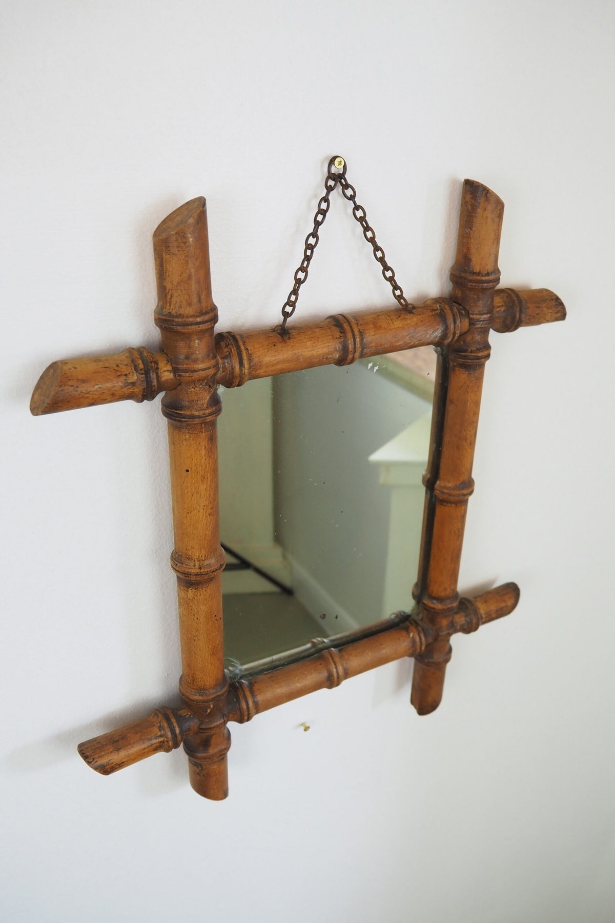 A stunning example of an early Antique French Faux Bamboo Mirror. This beautifully foxed glass is framed by a hand turned wooden frame.