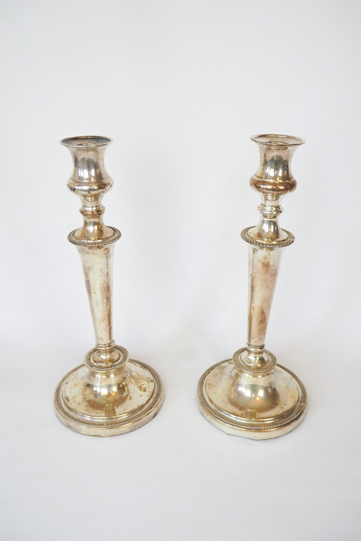 Stunning Pair of Georgian Silver Plate Candlesticks. This stunning pair of tall antique candle sticks are perfect for your coffee table or dinner party tablescape.