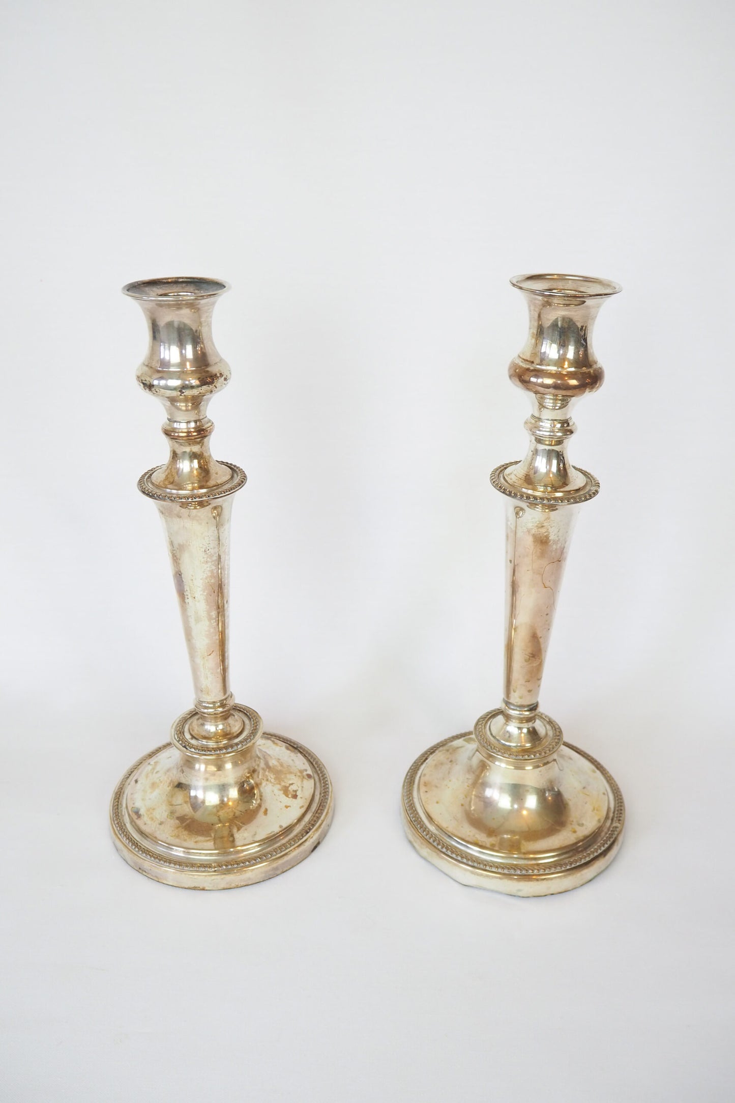 Stunning Pair of Georgian Silver Plate Candlesticks. This stunning pair of tall antique candle sticks are perfect for your coffee table or dinner party tablescape.