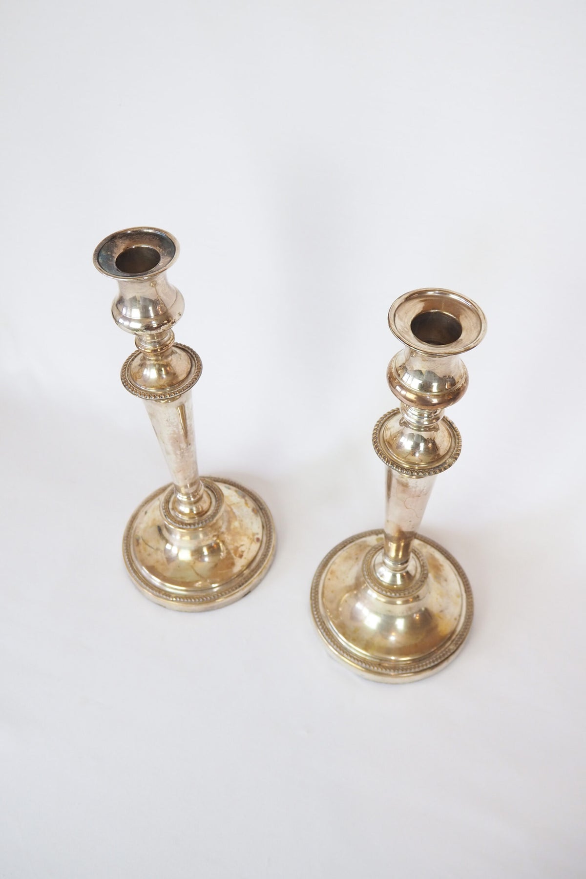 Stunning Pair of Georgian Silver Plate Candlesticks. This stunning pair of tall antique candle sticks are perfect for your coffee table or dinner party tablescape.