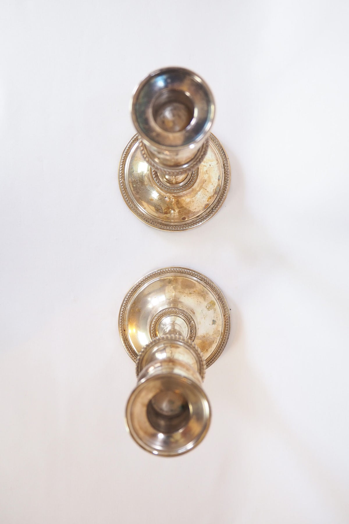 Stunning Pair of Georgian Silver Plate Candlesticks. This stunning pair of tall antique candle sticks are perfect for your coffee table or dinner party tablescape.