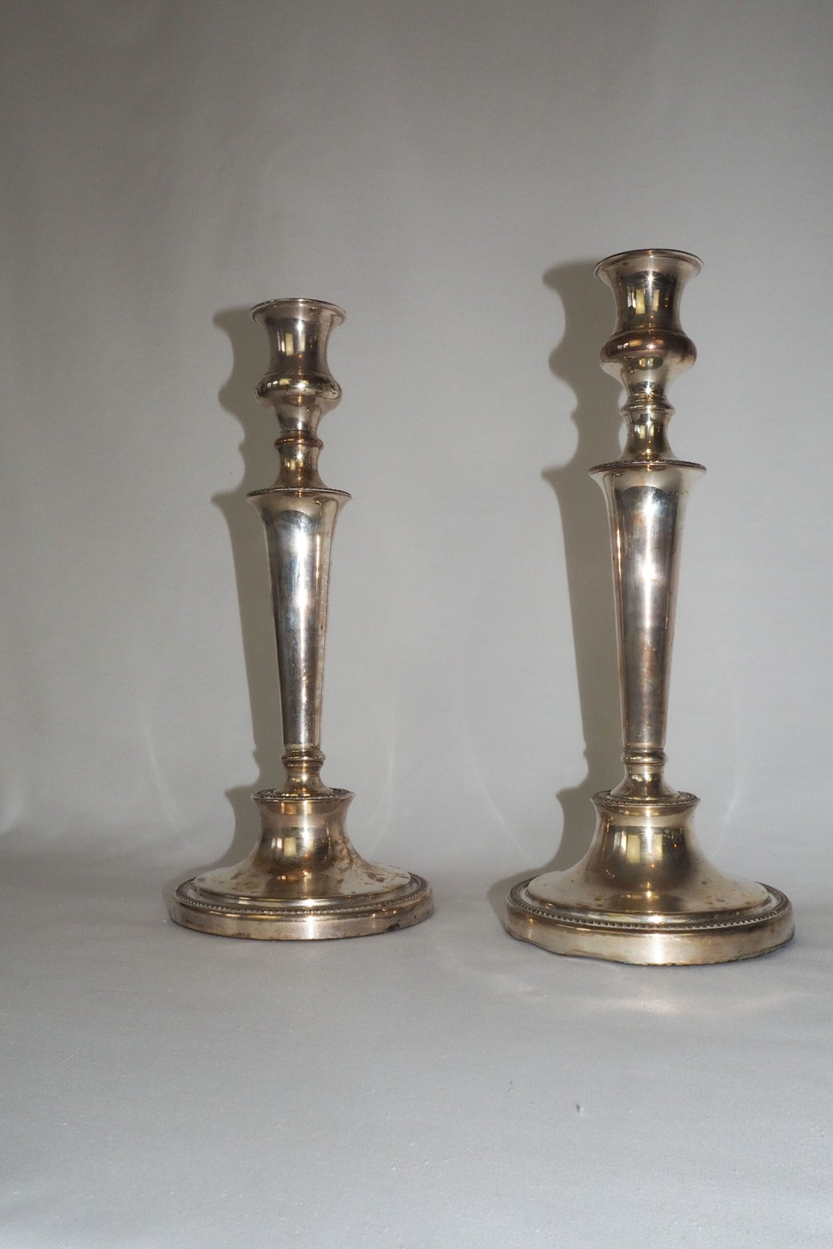 Stunning Pair of Georgian Silver Plate Candlesticks. This stunning pair of tall antique candle sticks are perfect for your coffee table or dinner party tablescape.