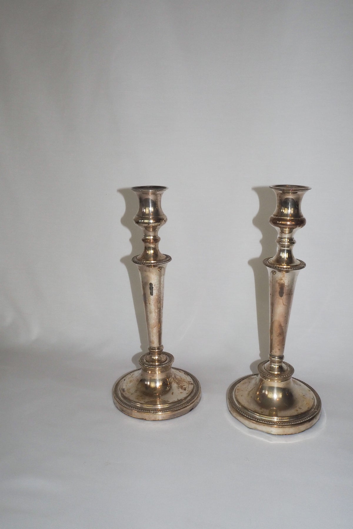 Stunning Pair of Georgian Silver Plate Candlesticks. This stunning pair of tall antique candle sticks are perfect for your coffee table or dinner party tablescape.