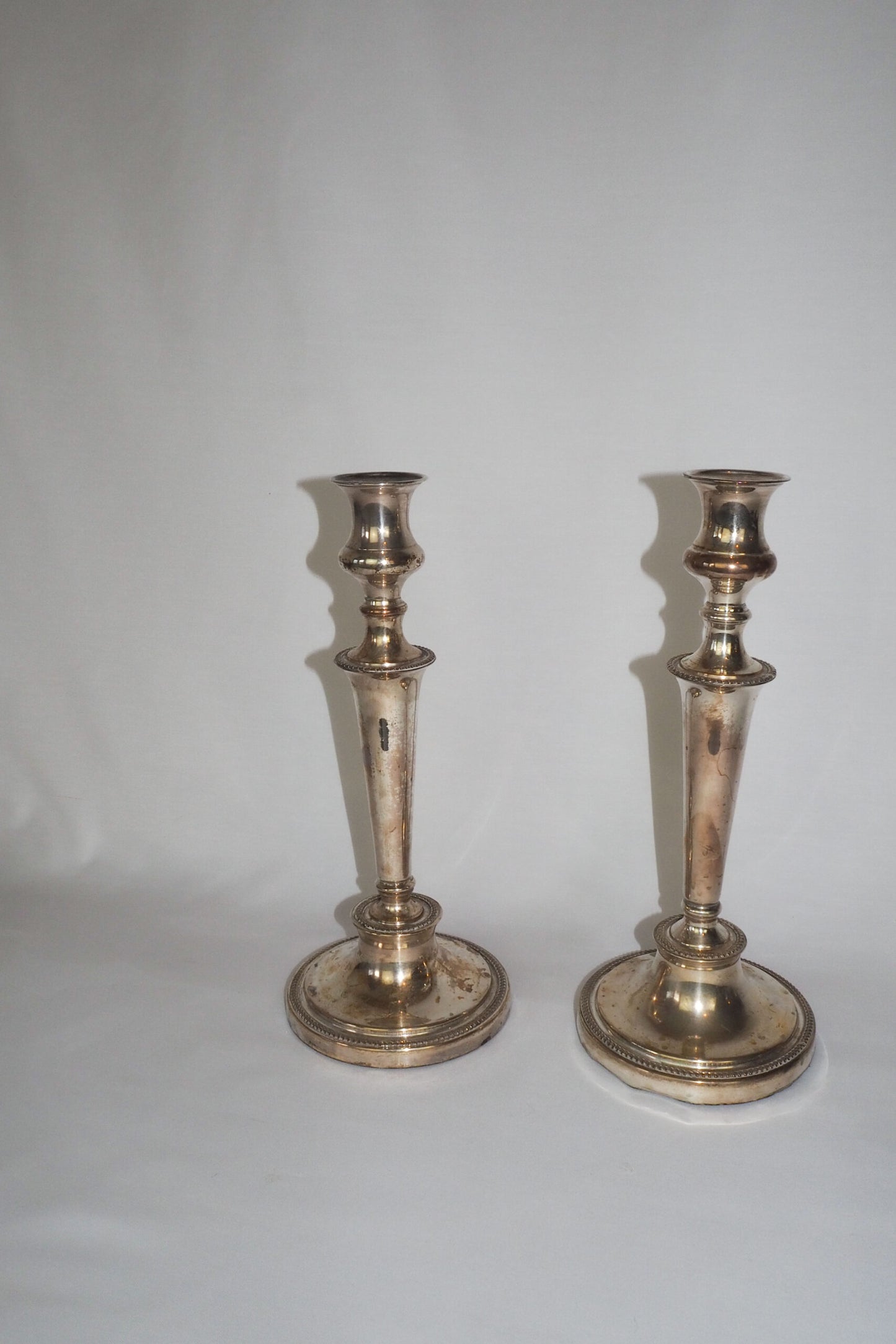 Stunning Pair of Georgian Silver Plate Candlesticks. This stunning pair of tall antique candle sticks are perfect for your coffee table or dinner party tablescape.