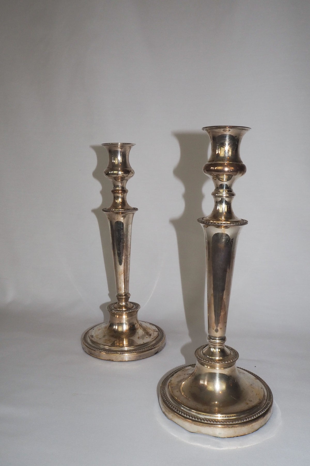 Stunning Pair of Georgian Silver Plate Candlesticks. This stunning pair of tall antique candle sticks are perfect for your coffee table or dinner party tablescape.