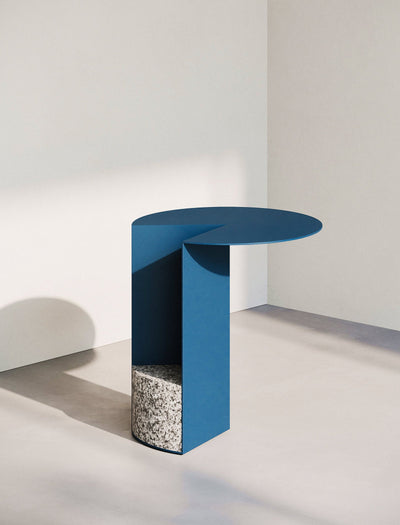 PAC Side Table - 700 with round blue aluminum top and solid granite base in minimalist setting.