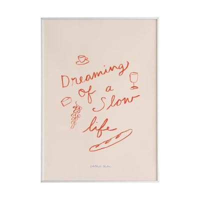 This mini art print features the phrase “Dreaming of a Slow Life” playfully surrounded by wine, cheese, grapes and a baguette painted in red on a white background. 