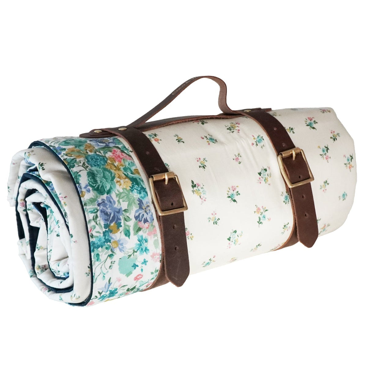 Roll-up floral picnic blanket with brown straps on a white background