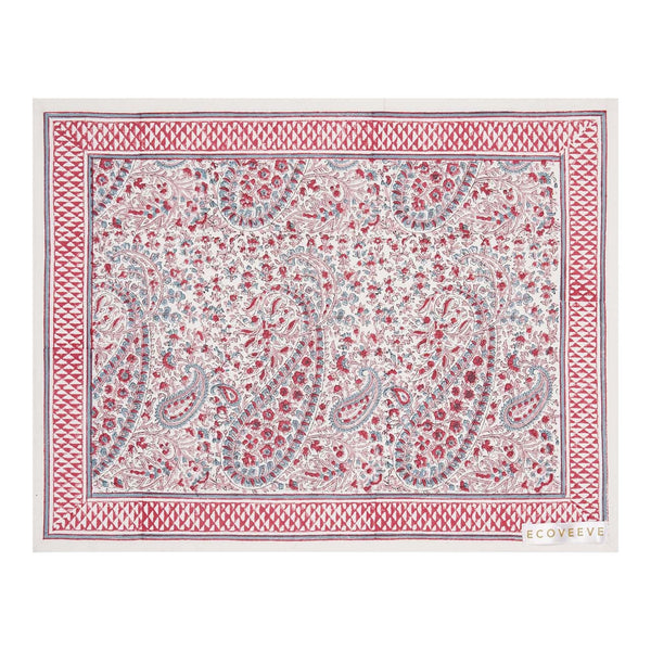 A hand-block printed pink and white floral patterned table mat.