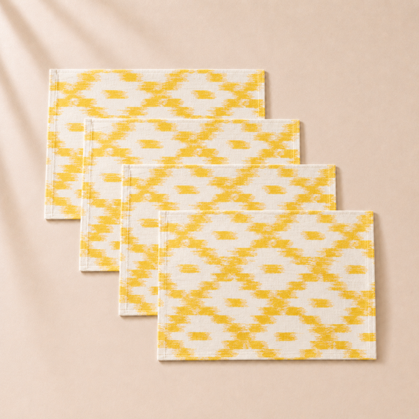 Set of three yellow and white patterned placemats on a beige background