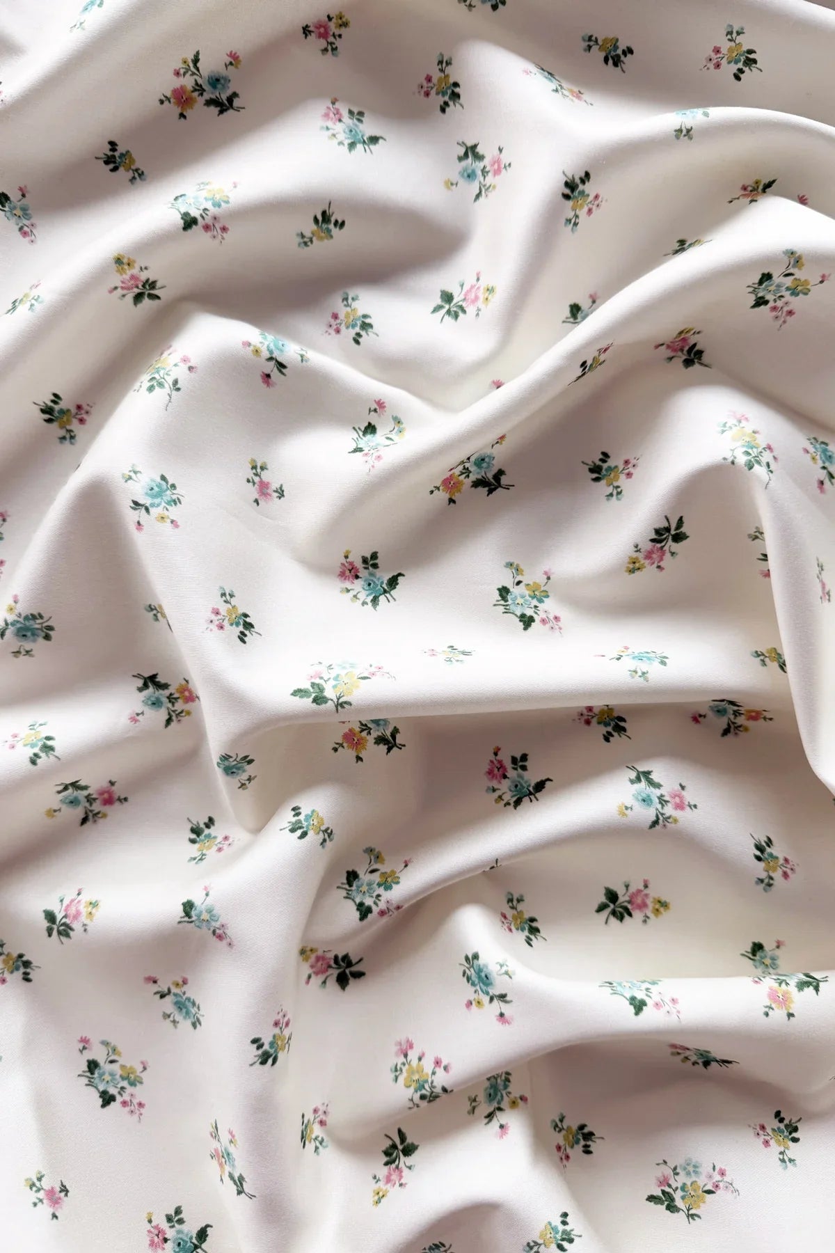 Floral patterned fabric with small flowers on a light background