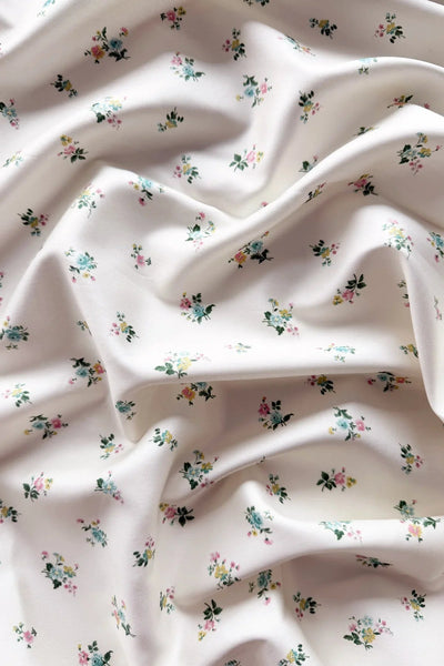 Floral patterned fabric with small flowers on a light background