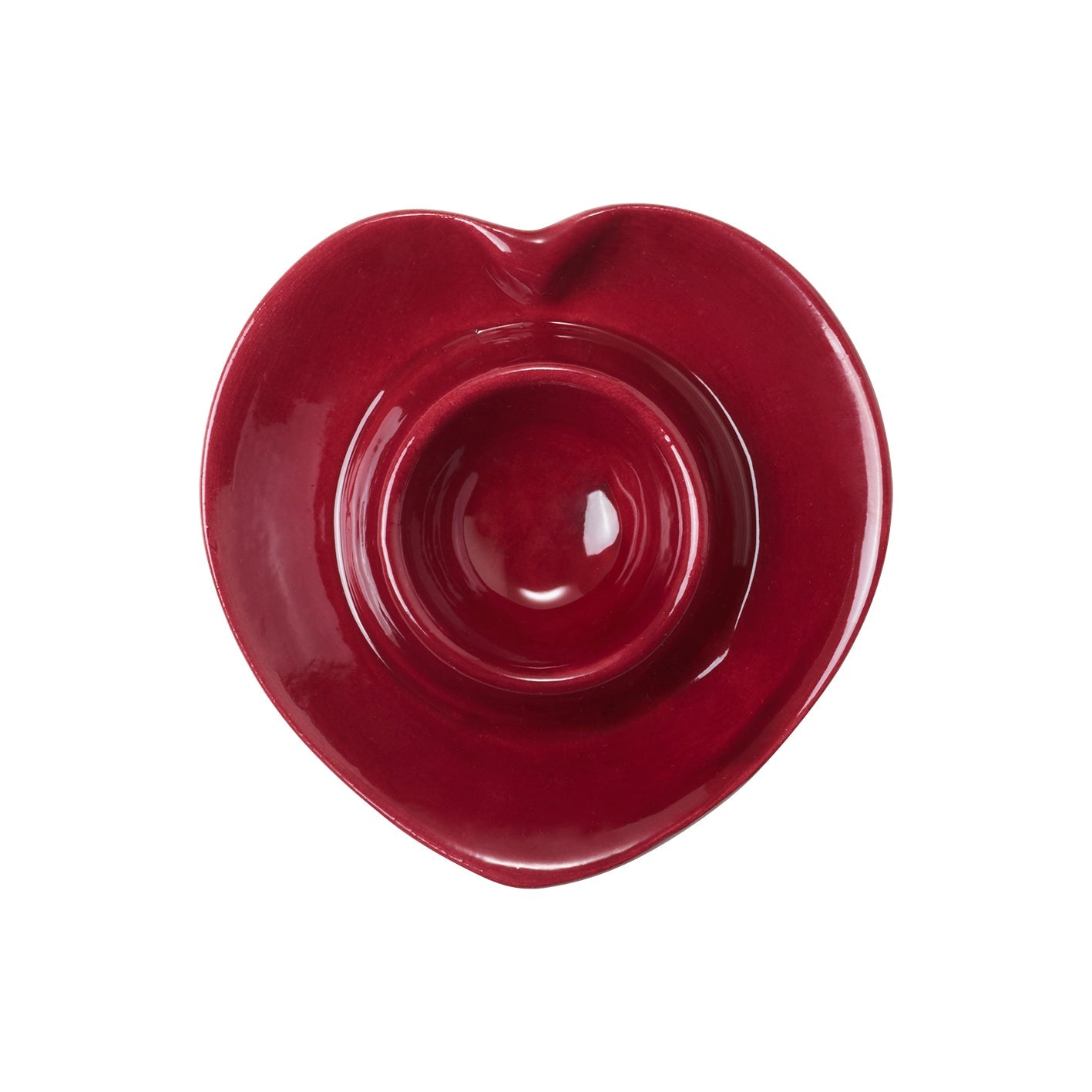 A red heart shaped ceramic egg cup seen from above on a white background.