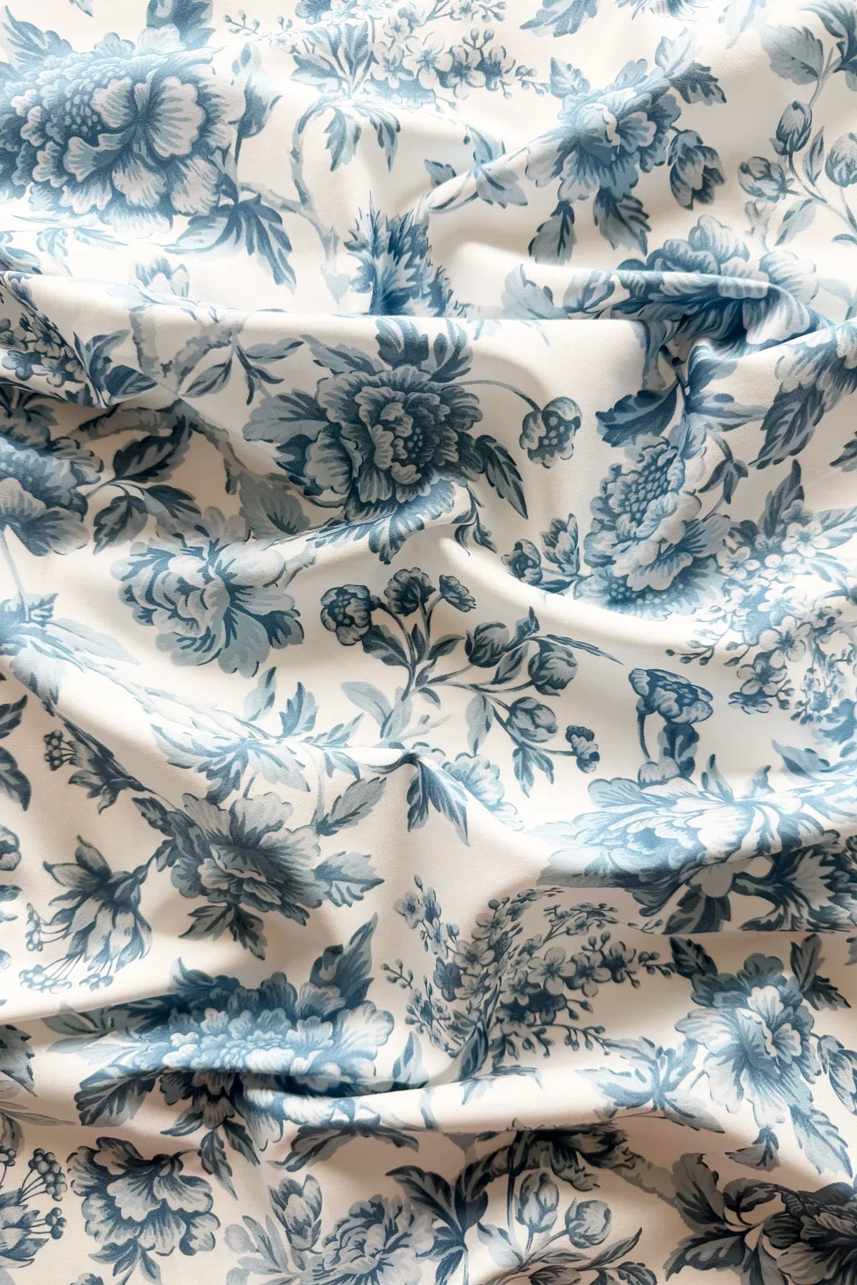 Floral patterned fabric with blue flowers on a white background