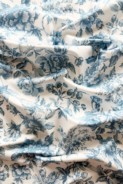 Floral patterned fabric with blue flowers on a white background