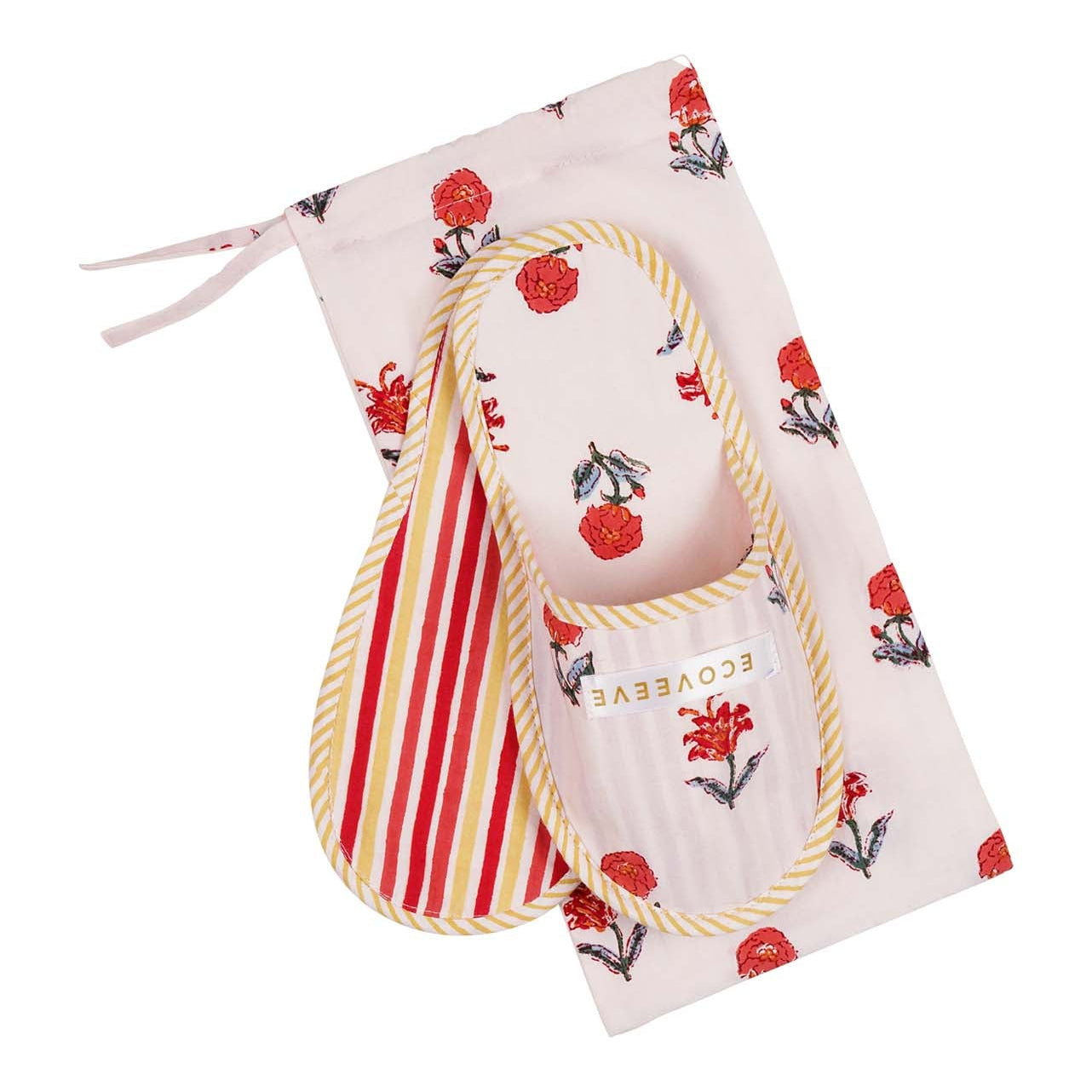 A pair of hand block-printed white cotton slippers with red and yellow floral patterns, displayed alongside a matching drawstring bag.