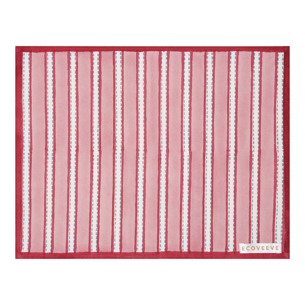 A striped block printed red and white table mat with a narrow border, laid out flat.