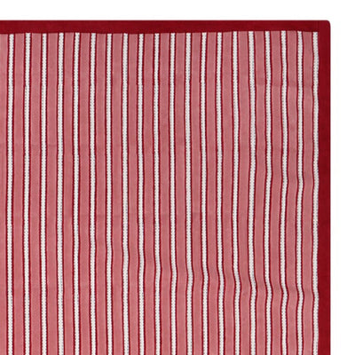 Red and white striped block printed tablecloth on a white background