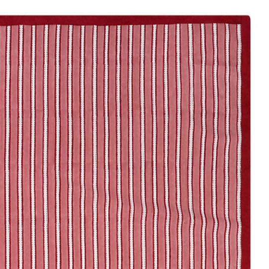 Red and white striped block printed tablecloth on a white background