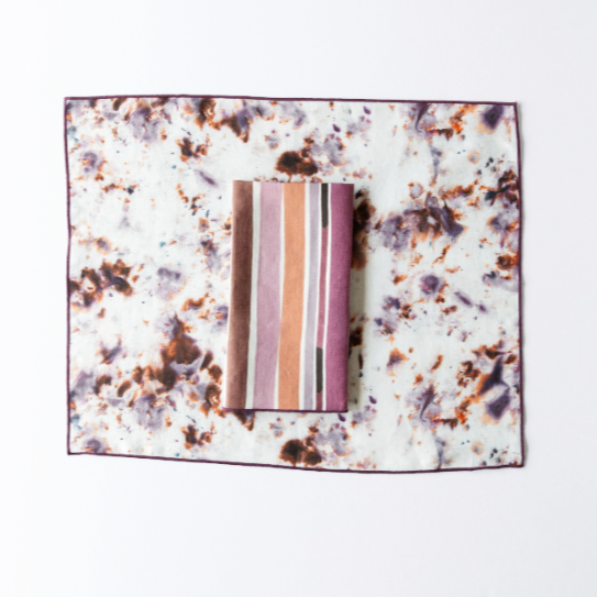 Rose Marble linen placemat styled on dining table with matching napkins - Goldie Home
