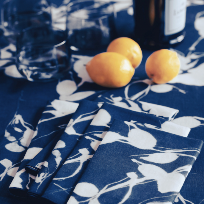 Porto Print Indigo linen tablecloth styled on elegant dining table with matching napkins - Goldie Home