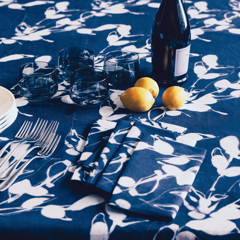 Porto Print Indigo linen tablecloth round 90 inch styled on round dining table - Goldie Home